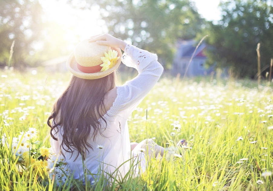 Girl In Sunny Grass With Hat